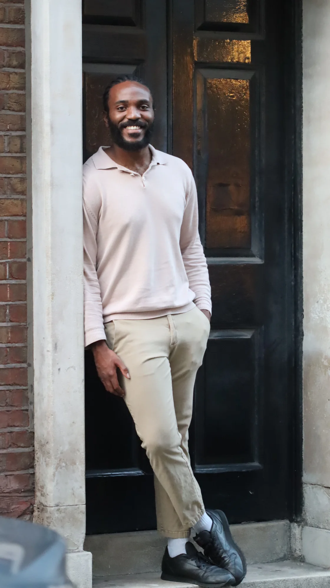 Marco Lewis standing outside a doorway